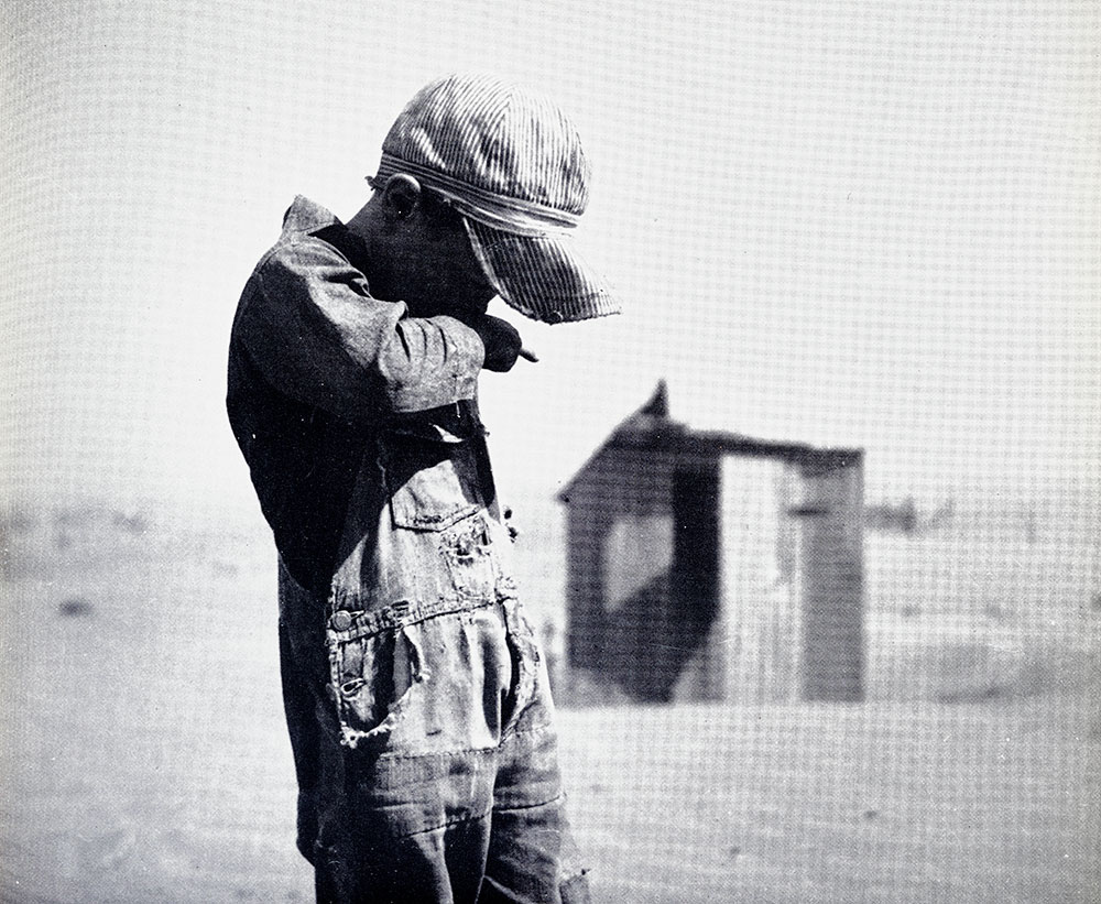 Photograph of a farm boy in a dust storm